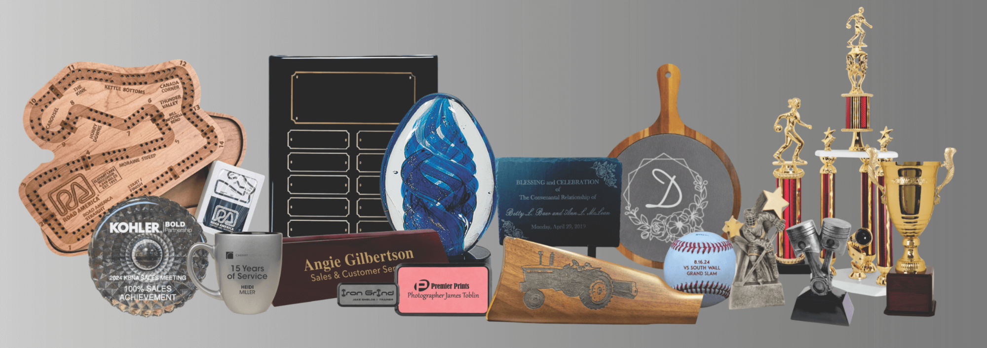 Collection of various awards and plaques on a gray background